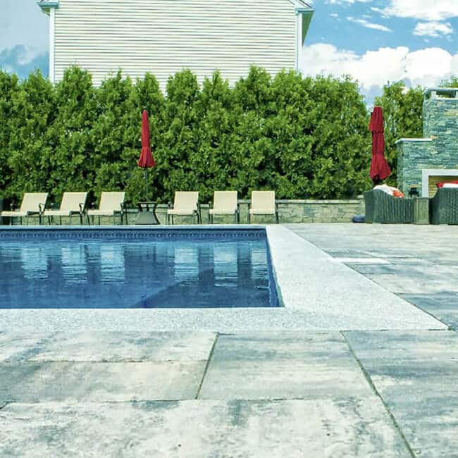 Stone pool deck in a home in Westport MA by Brian DeMedeiros BD Masonry.